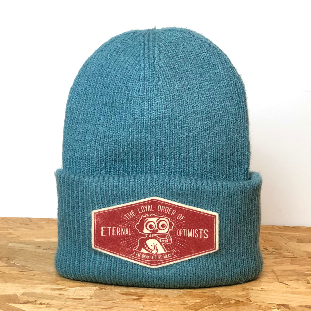 Loyal Order of Eternal Optimists marine green deep-cuffed 100% recycled polyester beanie, decorated with wool felt badge hand printed by All’s Well Originals with robot graphic and text 
